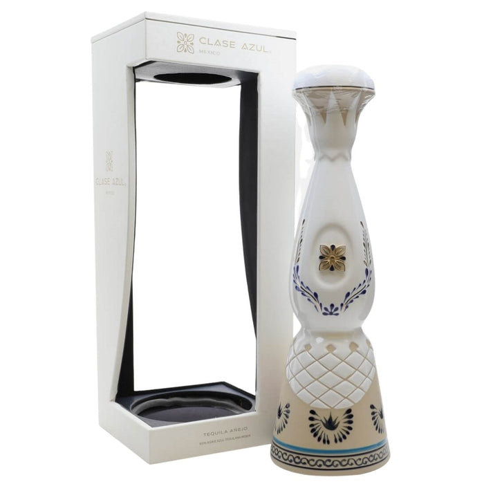 A ceramic tequila decanter from Clase Azul Tequila & Aromas, standing next to its white cardboard presentation box on a clean white background.