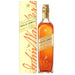 A bottle of Johnnie Walker Gold Label blended Scotch whisky next to its cream-colored packaging box, both featuring the brand's signature gold and orange lettering and logo, set against a plain white background.